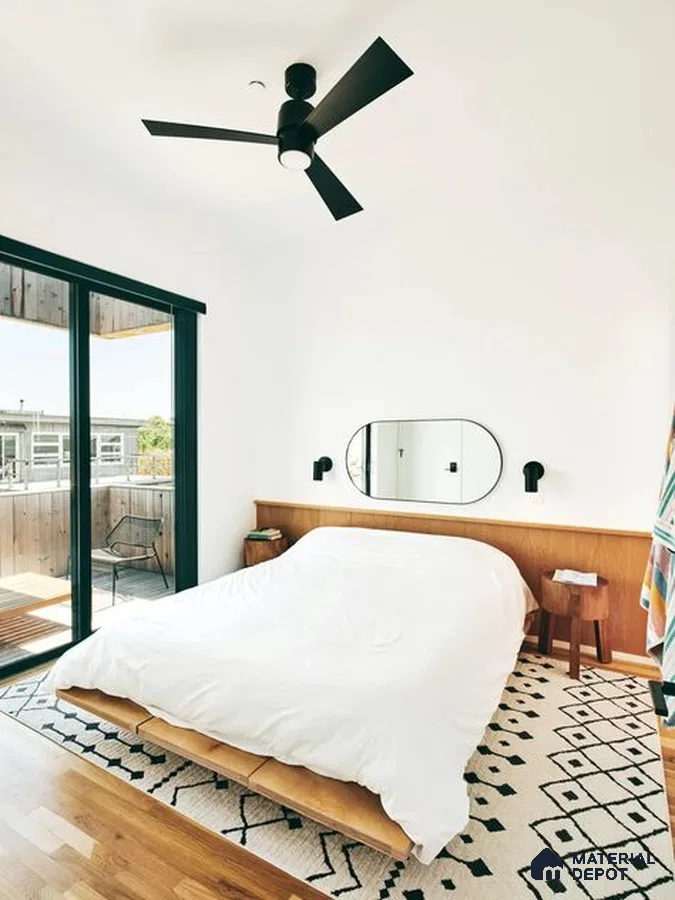 A room filled with lots of windows and a plant in the corner next to it on the floor of a stair case next to a wall mounted to a wall mounted to a window sill of a window